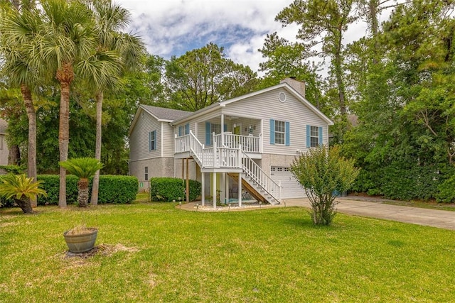 103 Travellers Way, Saint Simons Island, GA 31522 - rear view of house with stairway, a porch, concrete driveway, a yard, and a garage