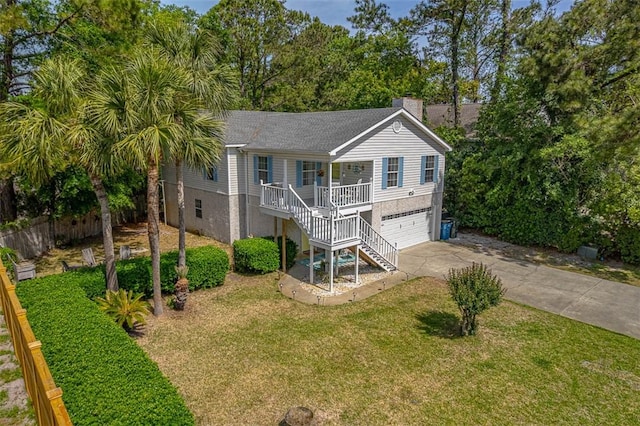 103 Travellers Way, Saint Simons Island, GA 31522 - view of front facade with a porch, stairs, concrete driveway, a chimney, and an attached garage