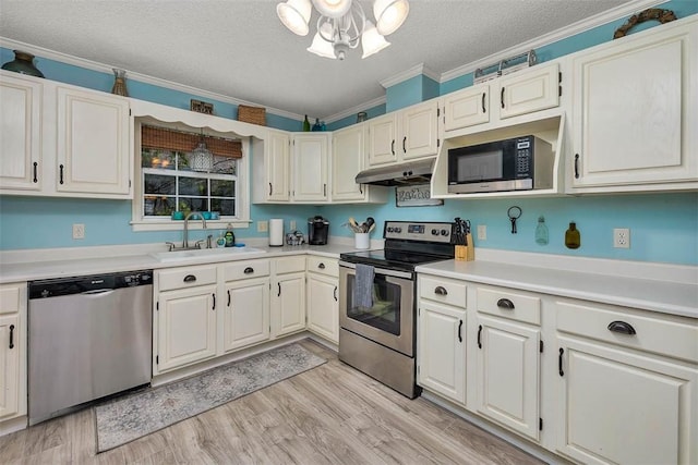 103 Travellers Way, Saint Simons Island, GA 31522 - kitchen featuring stainless steel appliances, light countertops, under cabinet range hood, crown molding, and a textured ceiling