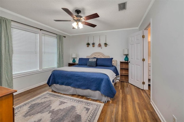 103 Travellers Way, Saint Simons Island, GA 31522 - bedroom with wood finished floors, crown molding, a textured ceiling, and ceiling fan