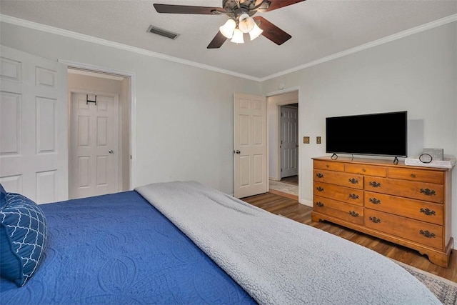 103 Travellers Way, Saint Simons Island, GA 31522 - bedroom with wood finished floors, crown molding, and ceiling fan