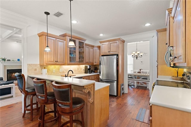 11 Bice Ct, Waverly, GA 31565 - kitchen featuring stainless steel appliances, a peninsula, hardwood / wood-style flooring, backsplash, and recessed lighting
