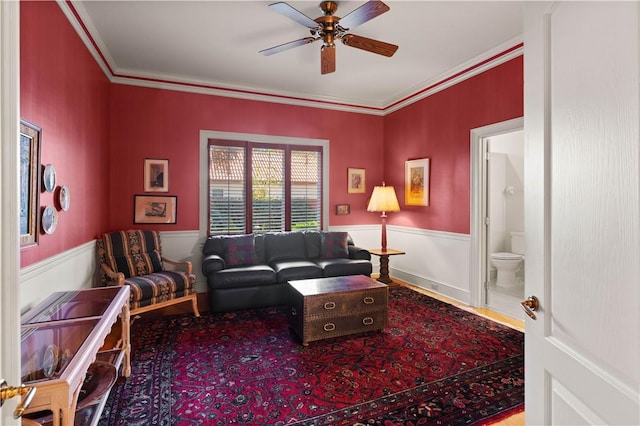 living room with crown molding and ceiling fan