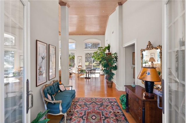 interior space with light wood-type flooring, high vaulted ceiling, and wood ceiling