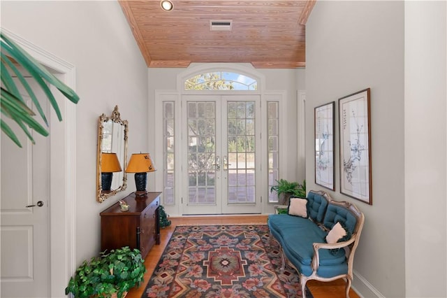 interior space featuring french doors, hardwood / wood-style flooring, and wood ceiling