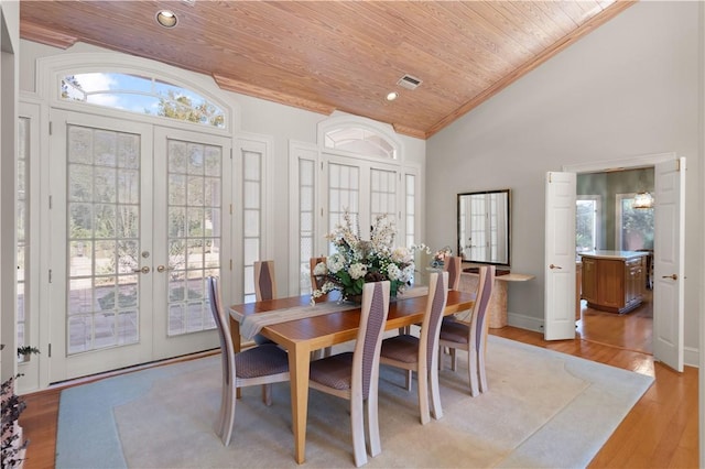 dining space featuring wood ceiling, french doors, high vaulted ceiling, and light hardwood / wood-style floors