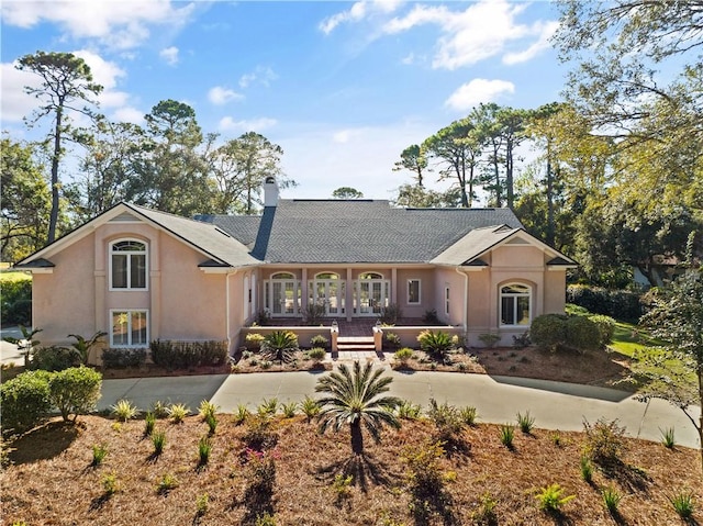 rear view of house with covered porch