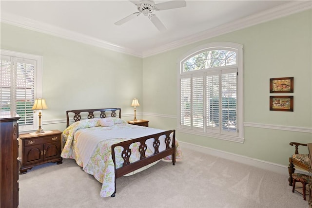 carpeted bedroom featuring ceiling fan and crown molding