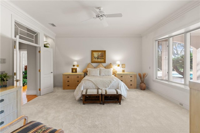 carpeted bedroom featuring ceiling fan and ornamental molding