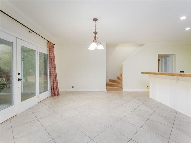 tiled empty room featuring a notable chandelier, crown molding, and french doors