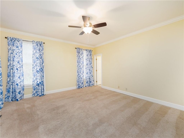 carpeted empty room featuring ceiling fan and ornamental molding