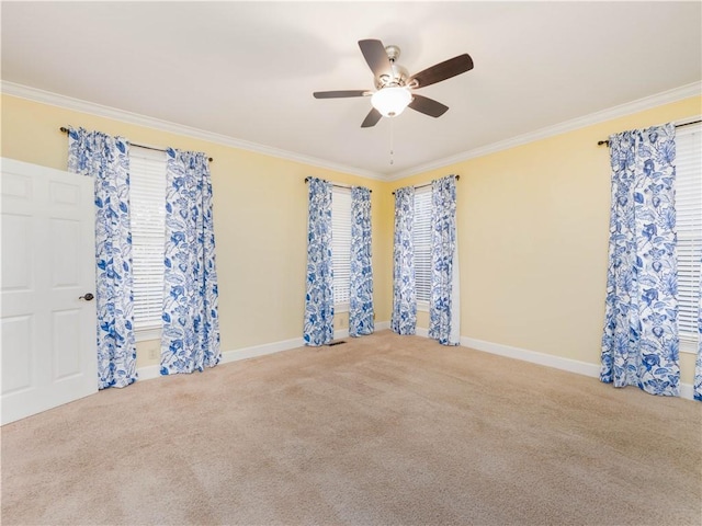 carpeted empty room featuring ceiling fan and ornamental molding