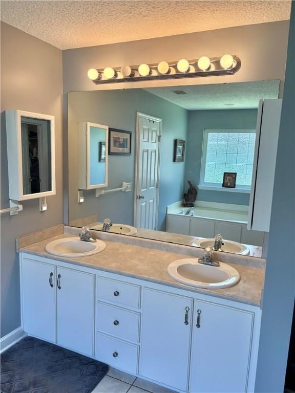 375 Wellington Pl, Brunswick, GA 31523 - full bath with double vanity, a textured ceiling, tile patterned flooring, and a tub