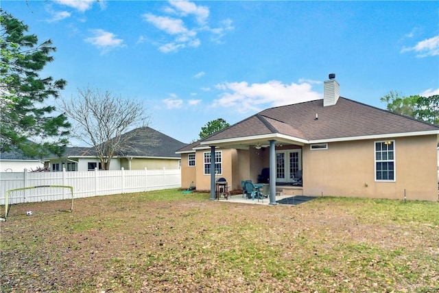 375 Wellington Pl, Brunswick, GA 31523 - back of house featuring stucco siding, a chimney, a patio area, and a shingled roof