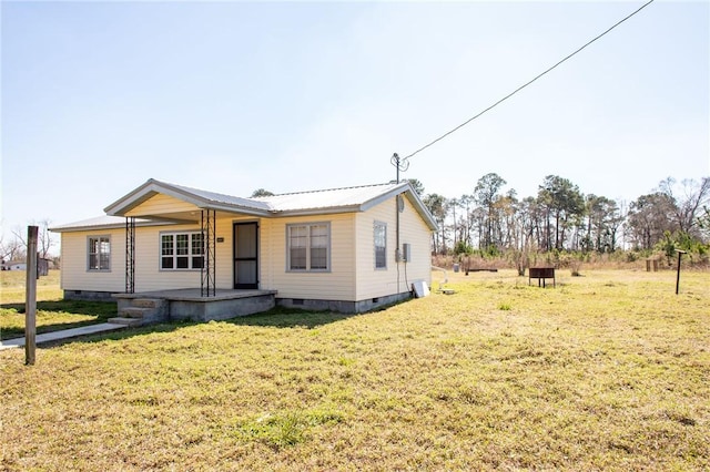 view of front of home with a porch, crawl space, a front yard, and metal roof
