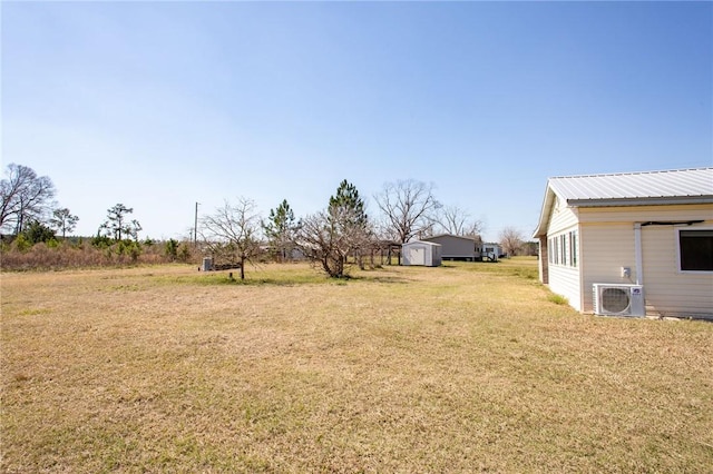 view of yard featuring an outdoor structure, ac unit, and a storage unit
