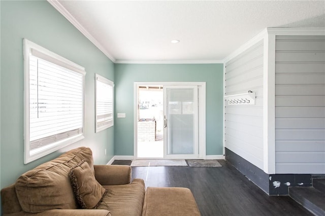 living room featuring baseboards, ornamental molding, and dark wood-style floors