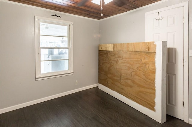 unfurnished room with crown molding, a ceiling fan, wooden ceiling, baseboards, and dark wood-style flooring