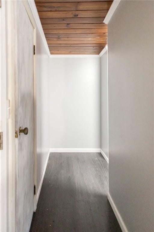interior space featuring baseboards, wooden ceiling, and wood finished floors