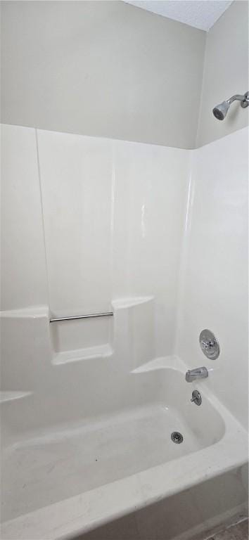 bathroom with washtub / shower combination