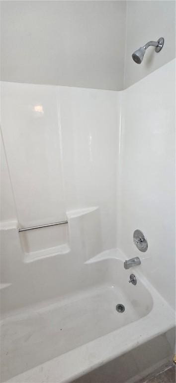 bathroom with shower / washtub combination