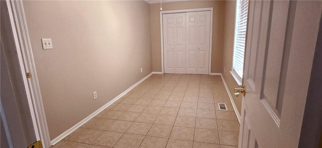 corridor featuring light tile patterned floors