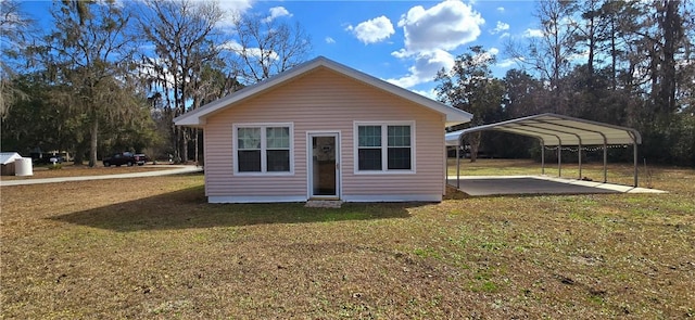 rear view of house with a carport and a lawn