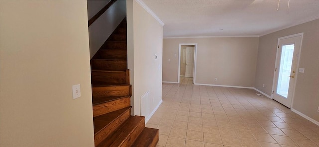 tiled entryway featuring ornamental molding