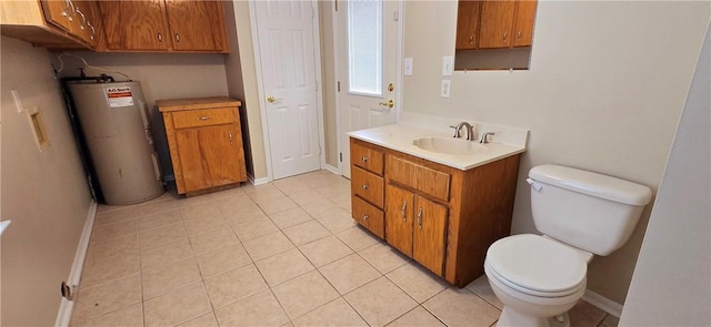 bathroom featuring vanity, toilet, tile patterned flooring, and water heater