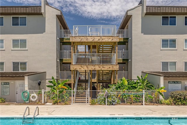 back of house featuring a community pool