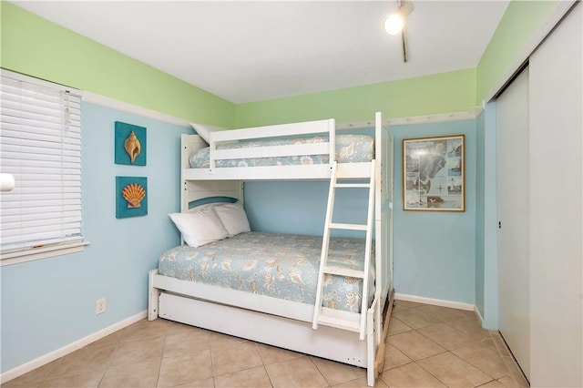 bedroom featuring light tile patterned floors and a closet