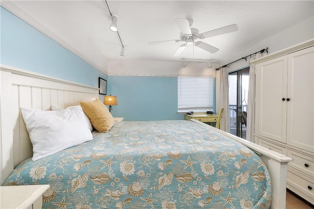 bedroom with ceiling fan and rail lighting