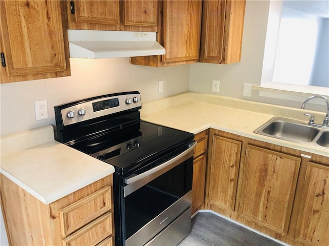 900 Lanier Blvd Unit 6, Brunswick, GA 31520 - kitchen featuring under cabinet range hood, stainless steel electric stove, light countertops, dark wood-type flooring, and brown cabinetry
