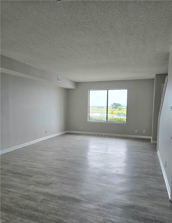 900 Lanier Blvd Unit 6, Brunswick, GA 31520 - spare room with dark wood-type flooring and a textured ceiling