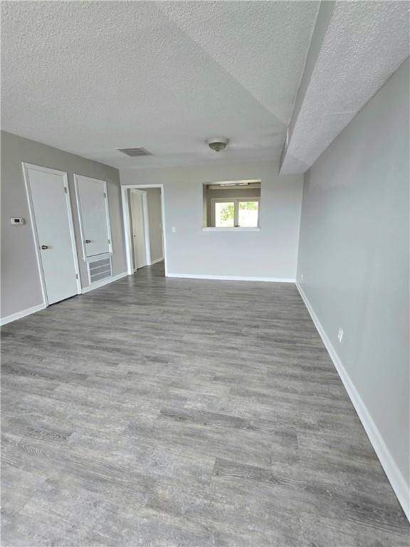 900 Lanier Blvd Unit 6, Brunswick, GA 31520 - unfurnished living room with a textured ceiling and wood finished floors