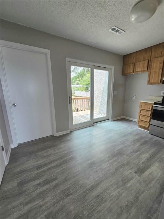 900 Lanier Blvd Unit 6, Brunswick, GA 31520 - kitchen featuring stainless steel electric stove, dark wood-type flooring, brown cabinets, a textured ceiling, and light countertops