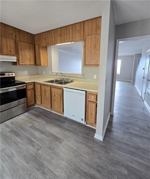 900 Lanier Blvd Unit 6, Brunswick, GA 31520 - kitchen with stainless steel electric stove, dishwasher, under cabinet range hood, dark wood finished floors, and light countertops