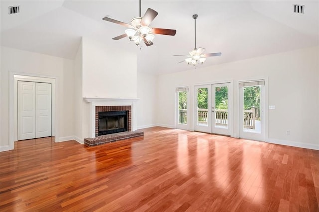 340 Oak Grove Island Dr, Brunswick, GA 31523 - unfurnished living room with a ceiling fan, wood finished floors, high vaulted ceiling, and a brick fireplace
