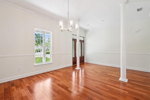 340 Oak Grove Island Dr, Brunswick, GA 31523 - unfurnished dining area featuring crown molding, wood finished floors, a chandelier, and decorative columns