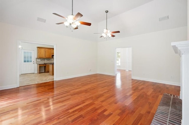 340 Oak Grove Island Dr, Brunswick, GA 31523 - unfurnished living room with ceiling fan, light wood finished floors, and high vaulted ceiling