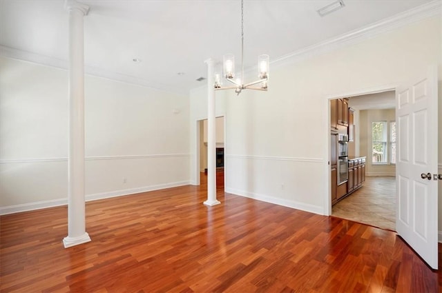 340 Oak Grove Island Dr, Brunswick, GA 31523 - unfurnished dining area with ornamental molding, wood finished floors, a chandelier, and decorative columns