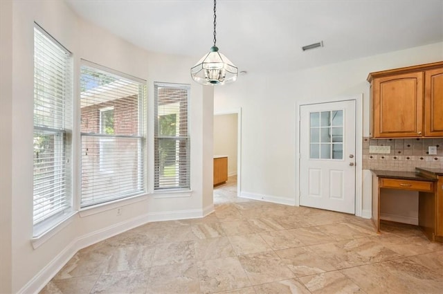 340 Oak Grove Island Dr, Brunswick, GA 31523 - unfurnished dining area featuring a chandelier and baseboards