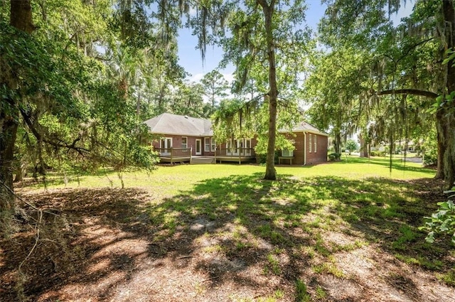 340 Oak Grove Island Dr, Brunswick, GA 31523 - view of grassy yard featuring a deck