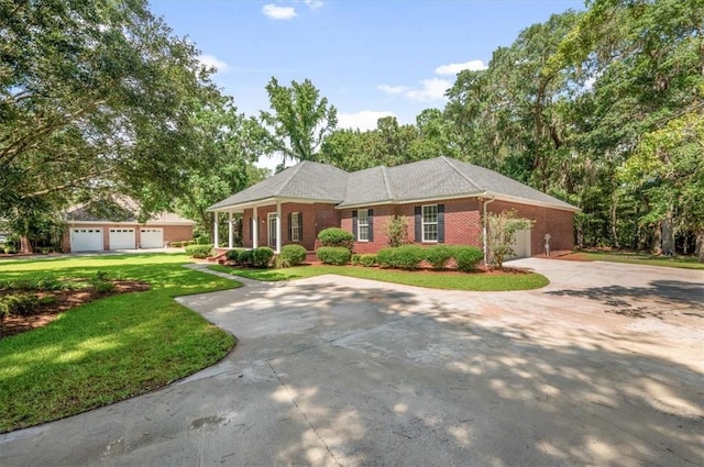 340 Oak Grove Island Dr, Brunswick, GA 31523 - view of front of property with concrete driveway, a front yard, brick siding, and an attached garage