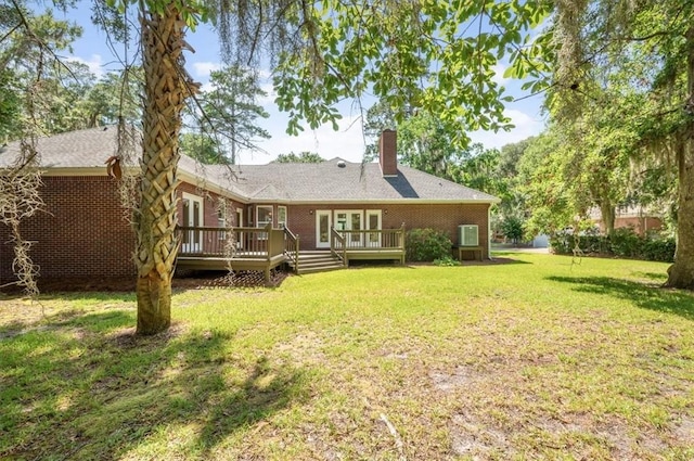 340 Oak Grove Island Dr, Brunswick, GA 31523 - back of house featuring a wooden deck, a chimney, french doors, a yard, and brick siding