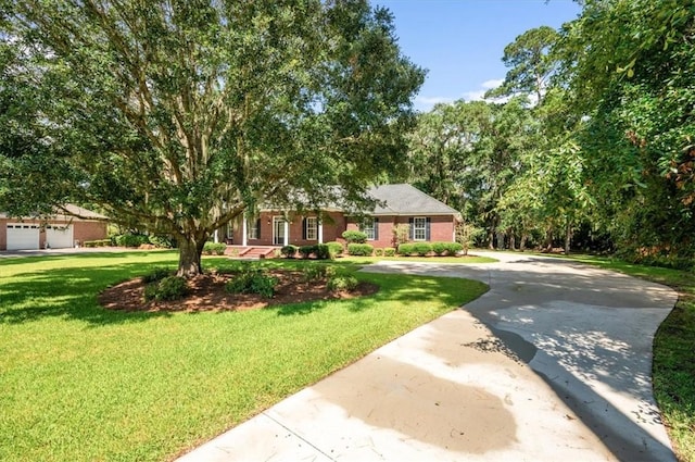 340 Oak Grove Island Dr, Brunswick, GA 31523 - view of front facade featuring concrete driveway, a front yard, and brick siding