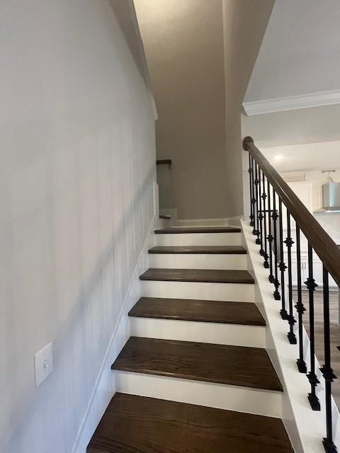 stairway featuring crown molding