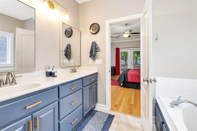 ensuite bathroom featuring a sink, french doors, a ceiling fan, and ensuite bathroom