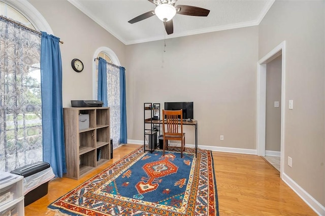 office area with crown molding, ceiling fan, wood finished floors, and baseboards