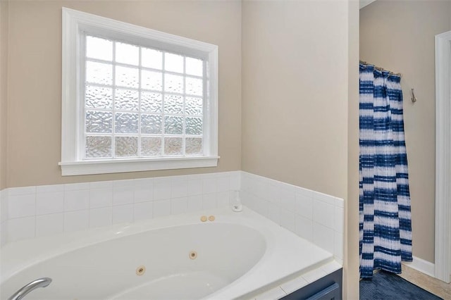 bathroom featuring a shower with shower curtain, a jetted tub, and a healthy amount of sunlight